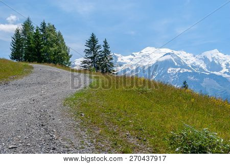 Plain Joux, France: Road Winding Up A Mountain Passing Alpine A Meadow And A Few Pine Trees. In The 