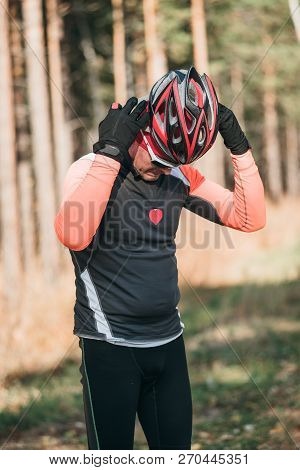 Training An Athlete On The Roller Skaters. Biathlon Ride On The Roller Skis With Ski Poles, In The H