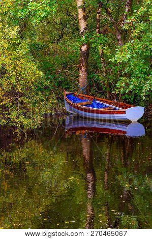 Boat And Trees With Reflection In Owenriff River