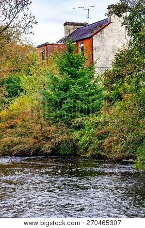 Owenriff River With Houses And Forest, Oughterard, Ireland