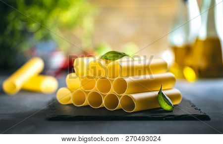 Fresh Raw Homemade Connelloni Pasta On Dark Table.