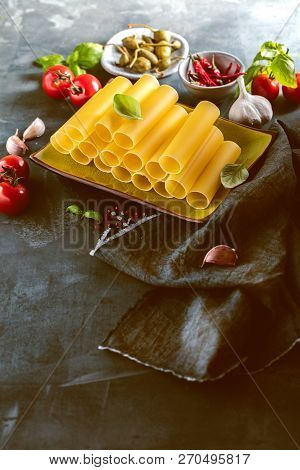 Fresh Raw Homemade Connelloni Pasta On Dark Table.