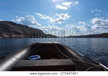 Rubber Fishing Boat Near Coastline Of Barents Sea In Northern Polar Summer. Arctic Ocean, Kola Penin