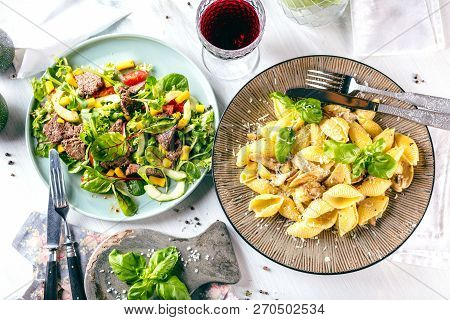 Fresh Salad Plate With Mixed Greens Arugula, Mesclun, Mache On Dark Wooden Background Close Up. Manz