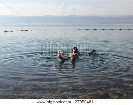 A man floats effortlessly in the salty water of the Dead Sea in Jordan