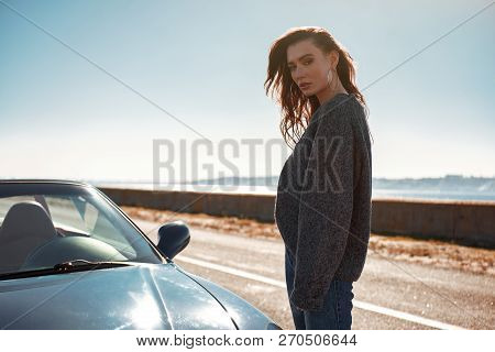 Young Woman Standing Near Roofless Car Outdoors On Sunny Day Near The Road