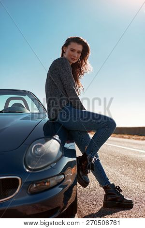 Young Woman Standing Near Roofless Car Outdoors On Sunny Day Near The Road