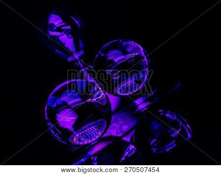 Purple And Blue Color Cover The Twin Lensballs And The Hour Glass In This Abstract Art Image.