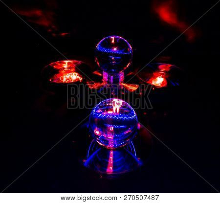 An Abstract Light Painting Image That Features Two Lensballs And Four Reflective Discs.