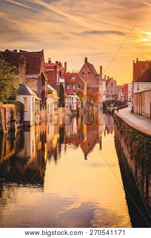 Scenic View Of The Historic City Center Of Brugge In Beautiful Golden Morning Light At Sunrise, Prov