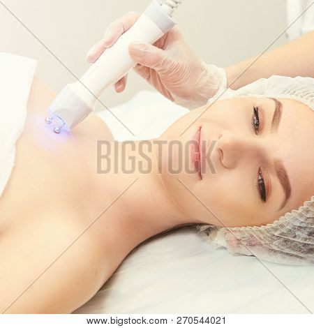 Facial Micro Current Cosmetology Procedure. Beauty Technology Treatment. Woman Face Therapy