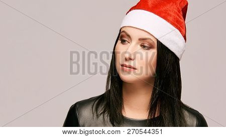 Young Girl In Santa Hat. New Year Beauty Portrait. Xmas People