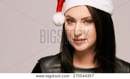 Young Girl In Santa Hat. New Year Beauty Portrait. Xmas People