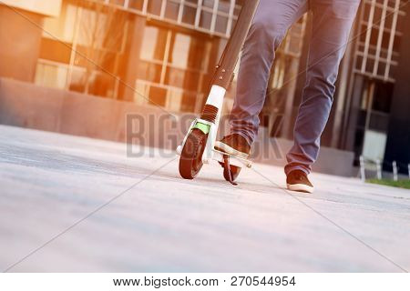 Close Up Image Of A Man On An Electric Scooter.