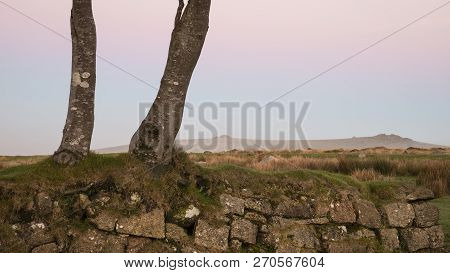 Stunning Foggy Sunrise Landscape Over The Tors In Dartmoor Revealing Peaks Through The Mist