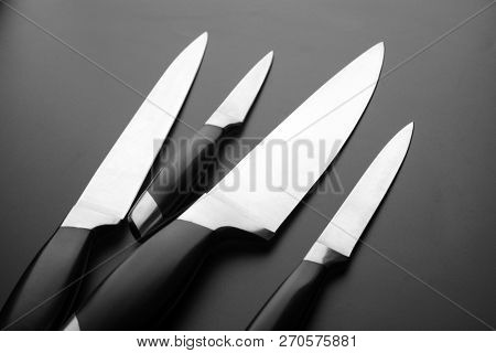 Collection of kitchen knives on black bfckground