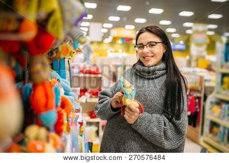 Happy future mother in glasses buys baby walkers
