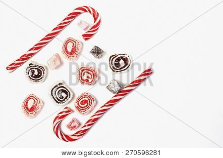 Sweet Candy Background. Red And Maroon Candies On White Background. Top View. Copy Space.