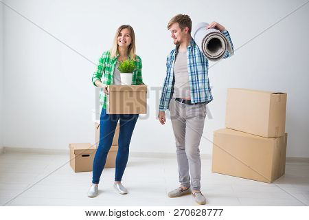 Relocation, Real Estate And Moving Concept - Young Cheerful Couple Moving Into Their New Home