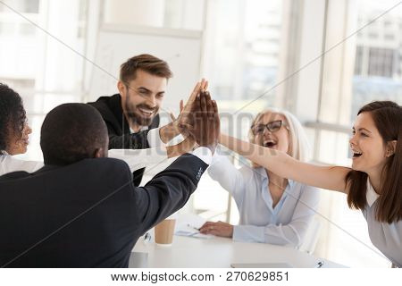 Excited Multiracial Office Associates Employees Group Giving Hig