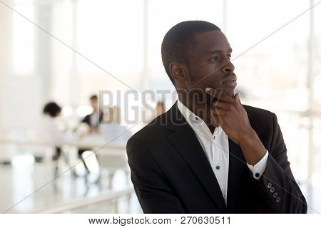 Thoughtful African Businessman Ceo Looking Away Thinking Of Futu