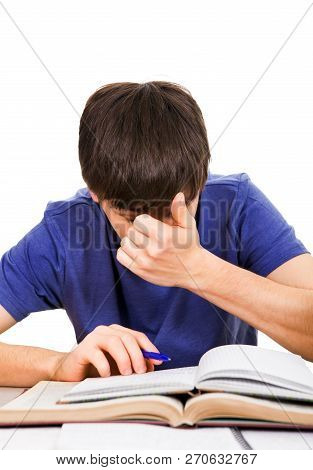 Tired Student Rub An Eyes On The School Desk Isolated On The White Background