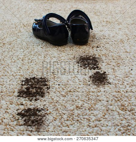 Dirty Floor And Children's Shoes. Concept Of Child Soiled Carpet.