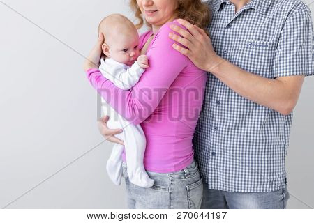 Family, Childhood And Parenthood Concept - Close Up Of Father, Mother Holding Cute Baby Over White B