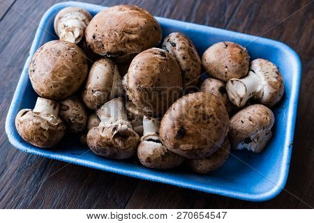 Portobello Raw Cremini Mushrooms In Plastic Container Package Or Box.