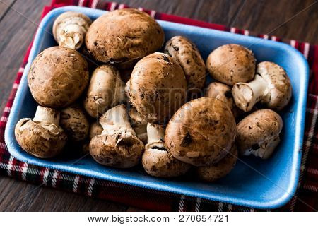 Portobello Raw Cremini Mushrooms In Plastic Container Package Or Box.