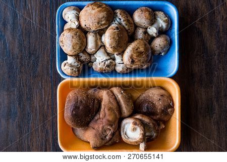 Shiitake And Cremini Mushrooms In Plastic Container Package Or Box.