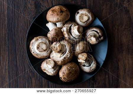Portobello Raw Cremini Mushrooms In Black Plate.