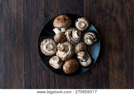 Portobello Raw Cremini Mushrooms In Black Plate.