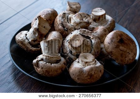 Portobello Raw Cremini Mushrooms In Black Plate.