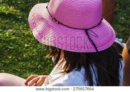 Big Pink Hat For A Child Girl Sitting On The Grass During A Public Event In Alsancak - Izmir (turkey
