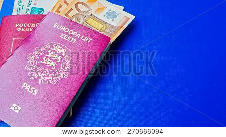 Passports On The Blue Background. Citizenship Of Estonia And Russia. Citizenship Of European Union (