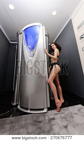 Beautiful Young Girl In Lingerie In A Beauty Salon On The Background Of A Cabin Of A Solarium