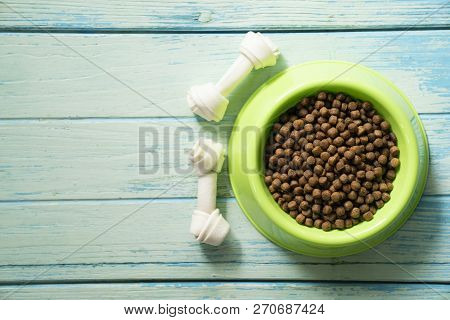 Dog Food And Dog Bone Snack Food On Wood Table