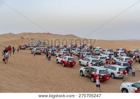 Dubai, Uae - Oct 10, 2018: Tourists And Large Group Of Toyota Landcruiser 4wd Parked On The Dunes As
