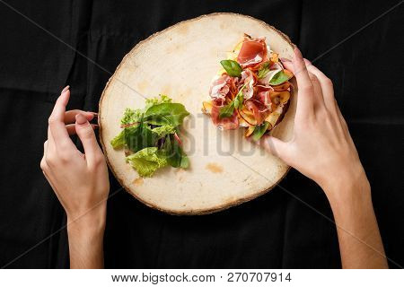 Top View Sandwich With Jamon And Salad On Board. Womans Hand Holding Folk And Knife. Sandwich With J