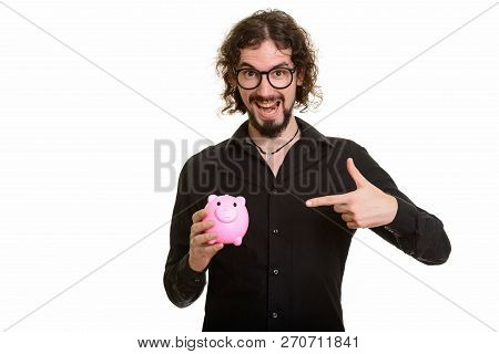 Happy Handsome Caucasian Man Holding Piggy Bank And Pointing Fin