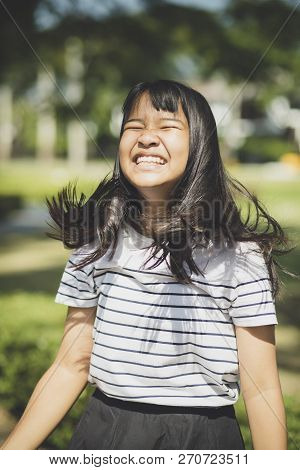 Kidding Face Of Asian Teenager Showns Forelock Hair Flowing By Wind