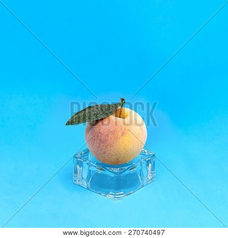Frozen Apple On Ice Cube On Blue Background. Creative Concept: Quickly Frozen Fruits And Vegetables 