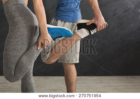 Couple Warming Up Legs Before Training At Gym. Unrecognizable Man And Woman Doing Stretching Exercis