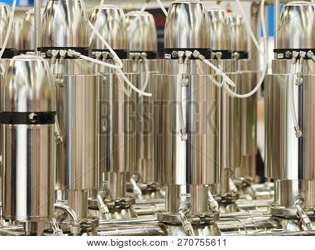 Vertical Cylinder Shaped Centrifuge Like Stainless Steel Tanks In A Cascade Arrangement