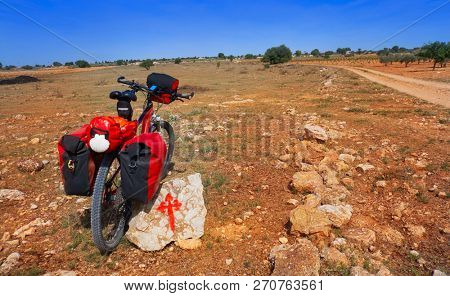 Saint James Way pilgrim bike and Templarios cross sign by Camino de Santiago of spain