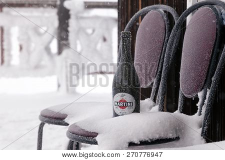 A Bottle Of Martini Asti Stands On A Chair Covered With Hoarfrost On The Terrace Of A Chalet In A Sk