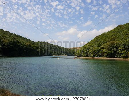 Fair Weather Clouds Over A River Valley On A Hot Summers Day