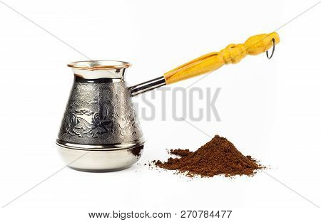 Jazva And A Pile Of Ground Coffee On A White Background