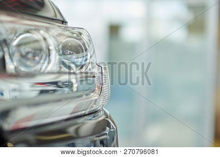 Crop Of Isolated Headlight Of Big Powerful Black Car. Close Up Of Front Part Of New Expencive Vehicl